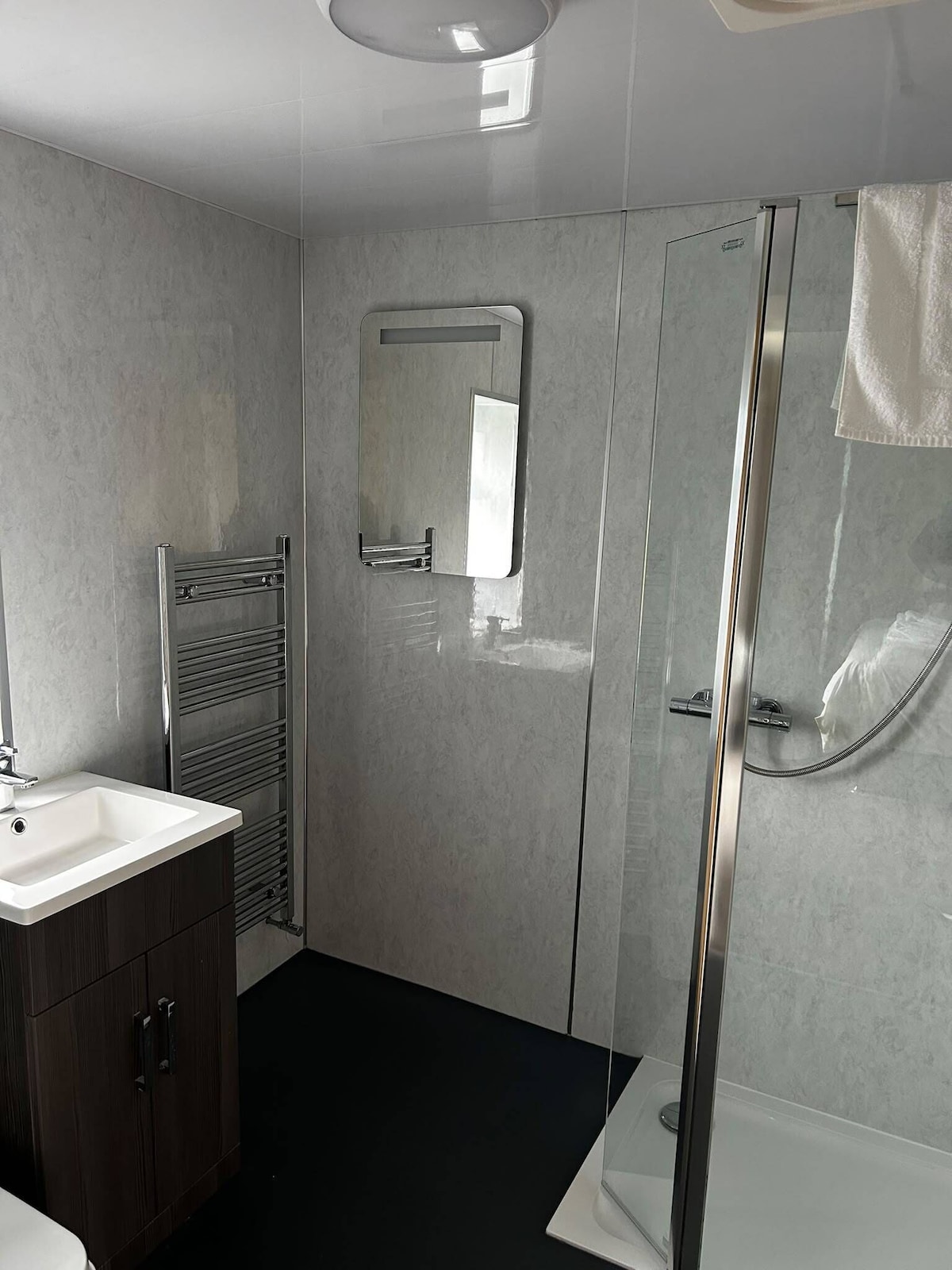 Modern en-suite bathroom with heated towel rail