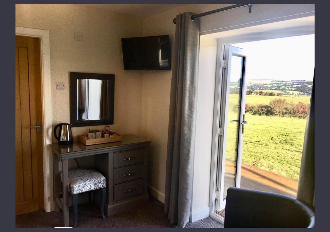Guest room with tea facilities and doors opening to the countryside